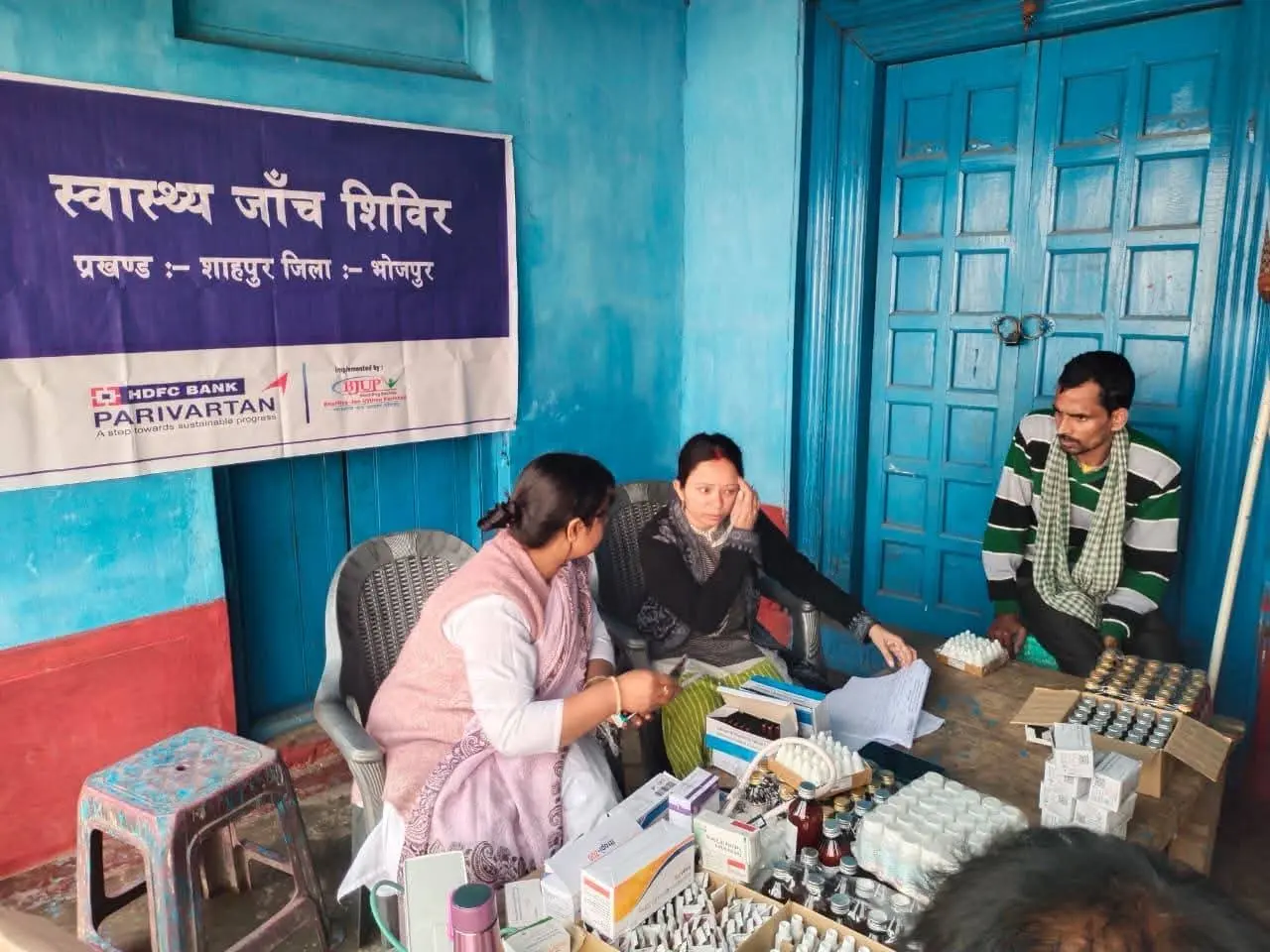 Distribution of medicines at a rural health checkup camp in Bhojpur supported by HDFC Bank Parivartan and Health and WASH NGO in Bihar BJUP