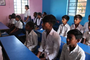 Students and a teacher inside a community library safe space managed by Child Protection NGO in Bihar BJUP and RMI in the Mica Belt region